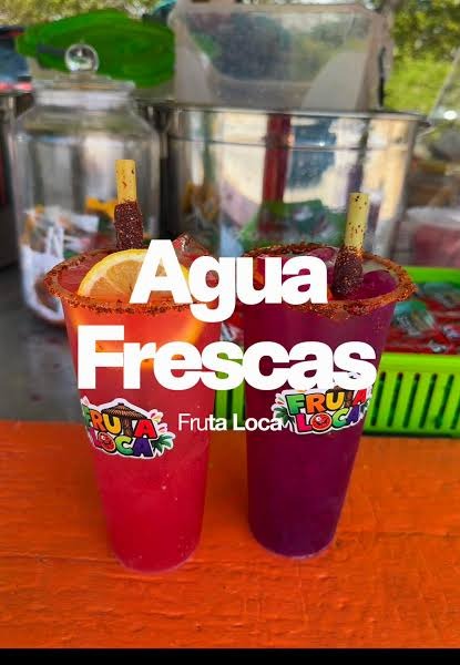 Two cups with chamoy rims and tamarind sticks